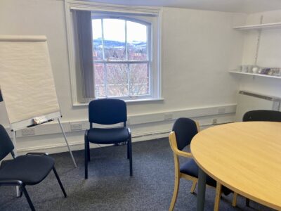 A meeting room at Hampshire Workspace in Winchester UK showing a chart on an easel and a table and chairs
